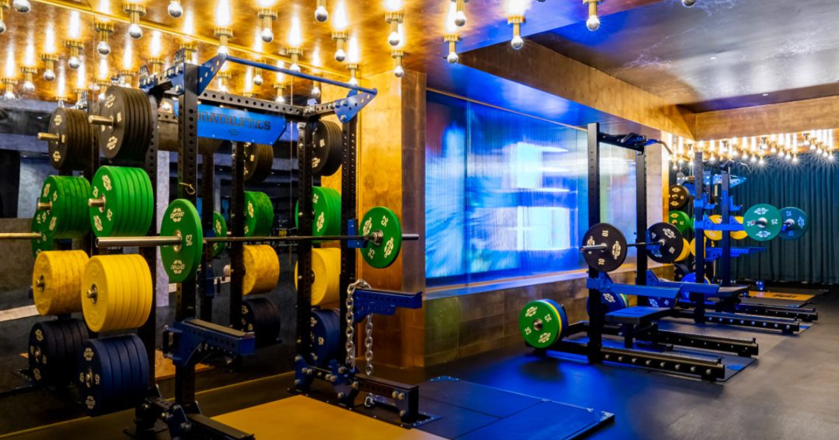 Custom Gym80 80Athletics rigs and racks with color-coded Olympic plates, welded steel construction, and modular training stations designed for strength, functional, and high-performance athletes.