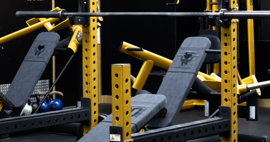 close up of gym80 strength equipment training station with rack and incline bench showcasing welded commercial gym equipment built for biomechanics and stability