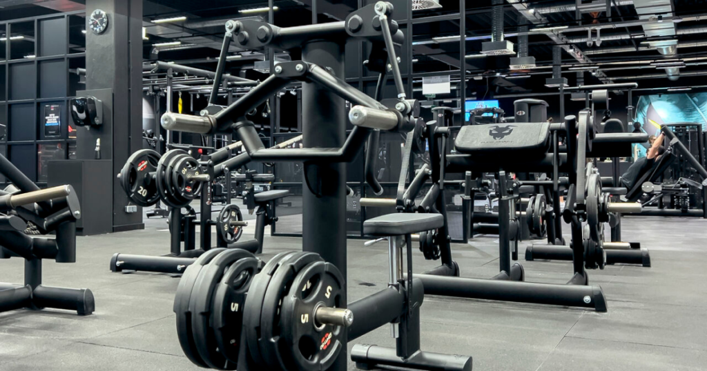 Plate loaded strength machines in a professional gym designed for heavy resistance training and improved muscle engagement.