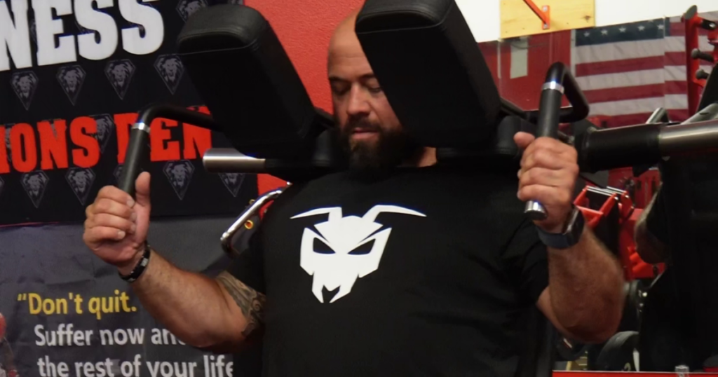 Professional athletes training on a biomechanically engineered shoulder press machine designed to improve strength training performance and muscle engagement.